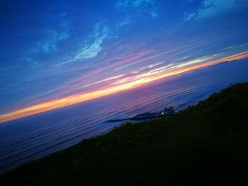 Scenic view of sea against sky at night