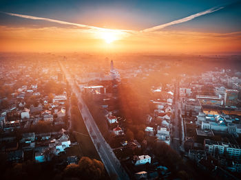 High angle view of street amidst buildings against sky during sunset