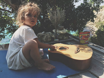 Cute girl sitting by guitar