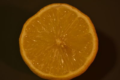 Close-up of lemon slice against black background