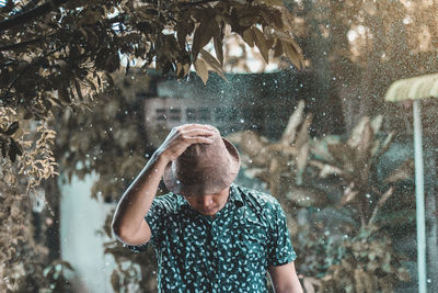 Midsection of man against trees