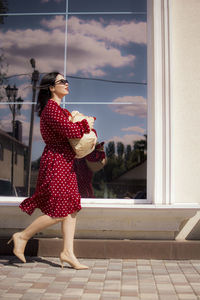 Rear view of woman with arms raised