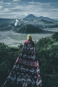 Rear view of person against mountains