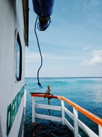 Ship sailing in sea against sky