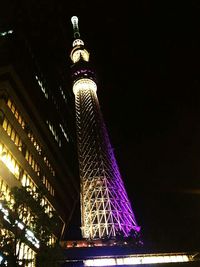 Low angle view of communications tower at night