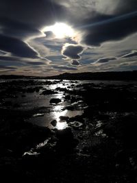 Scenic view of sea against cloudy sky