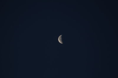 Low angle view of moon against clear sky at night