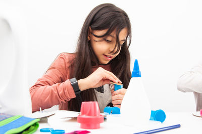 Young girl playing a life sciences professional role. could be biologist, doctor, researcher. 