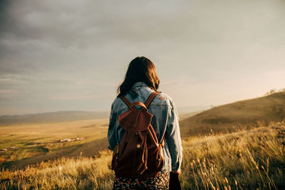 Rear view of woman looking at field