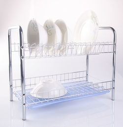 Crockeries on rack against white background