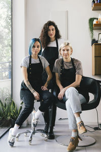 Portrait of confident female hairdressers in salon