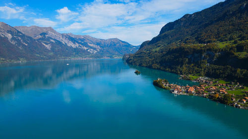 Scenic view of lake and mountains against sky