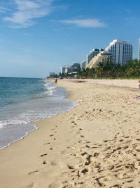 Scenic view of beach against sky in city