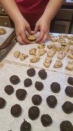 Midsection of person preparing cookies