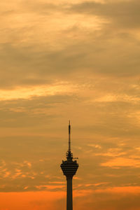 Low angle view of tower against cloudy sky