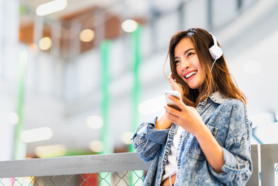 Young woman using mobile phone outdoors