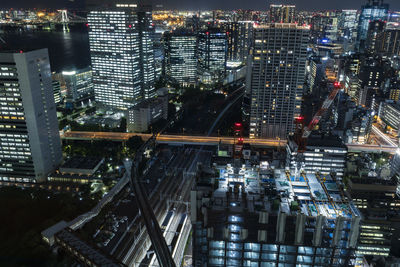 High angle view of illuminated buildings in city at night