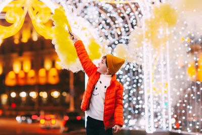 A teenage boy with a smoke bomb in his hands during the celebration of christmas or new 