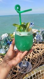 Cropped hand of woman holding drink