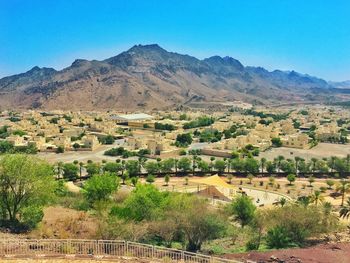 High angle view of houses by mountains against sky