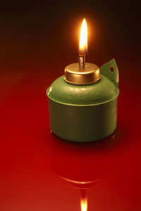 Close-up of illuminated oil lamp on table