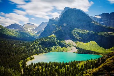 Scenic view of lake and mountains against sky