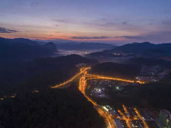 High angle view of illuminated bridge against sky at sunset