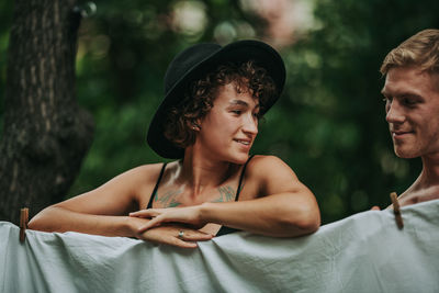 Portrait of young man looking away outdoors