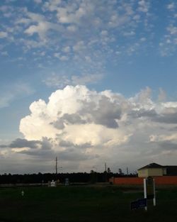 Houses on field against sky