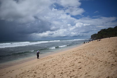 Man on beach against sky