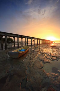 Scenic view of beach against sky during sunset