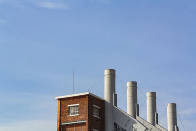 Low angle view of factory against sky