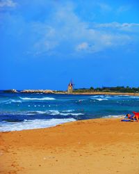 Scenic view of beach against blue sky