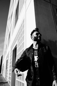 Low angle view of man standing against sky