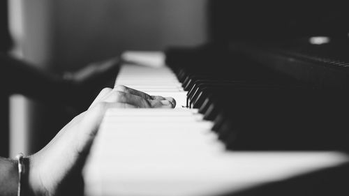 Cropped hand of person playing piano
