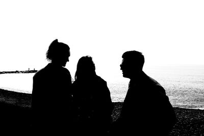 Silhouette people standing against white background