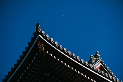 Low angle view of temple against clear blue sky