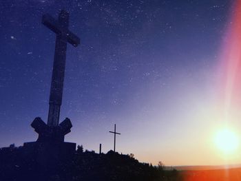 Low angle view of silhouette cross against sky at sunset