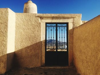 Door on old building against blue sky