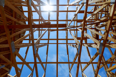 Low angle view of roof beam against sky