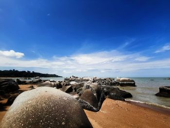 Rocks on beach against sky