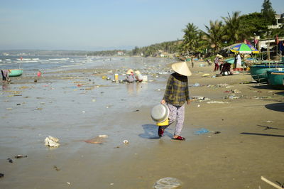 Man working on garbage at beach