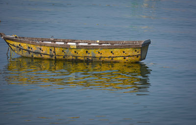 Abandoned boat moored in lake