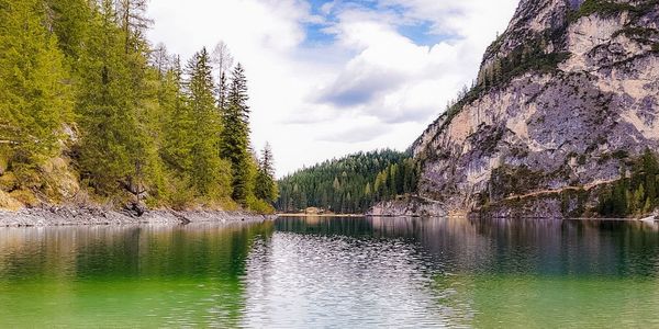 Scenic view of lake against cloudy sky