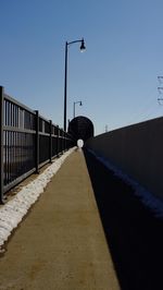 Bird on bridge against clear sky