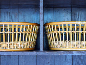 Wicker baskets on wooden shelf