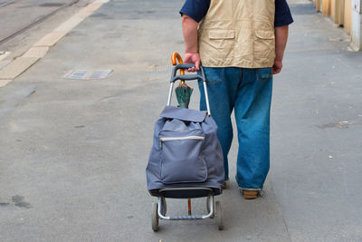 Low section of man walking on road