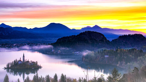 Scenic view of lake against sky during sunset