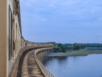 Arch bridge over river against sky