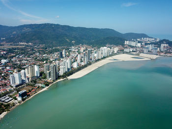 Scenic view of sea and buildings against sky